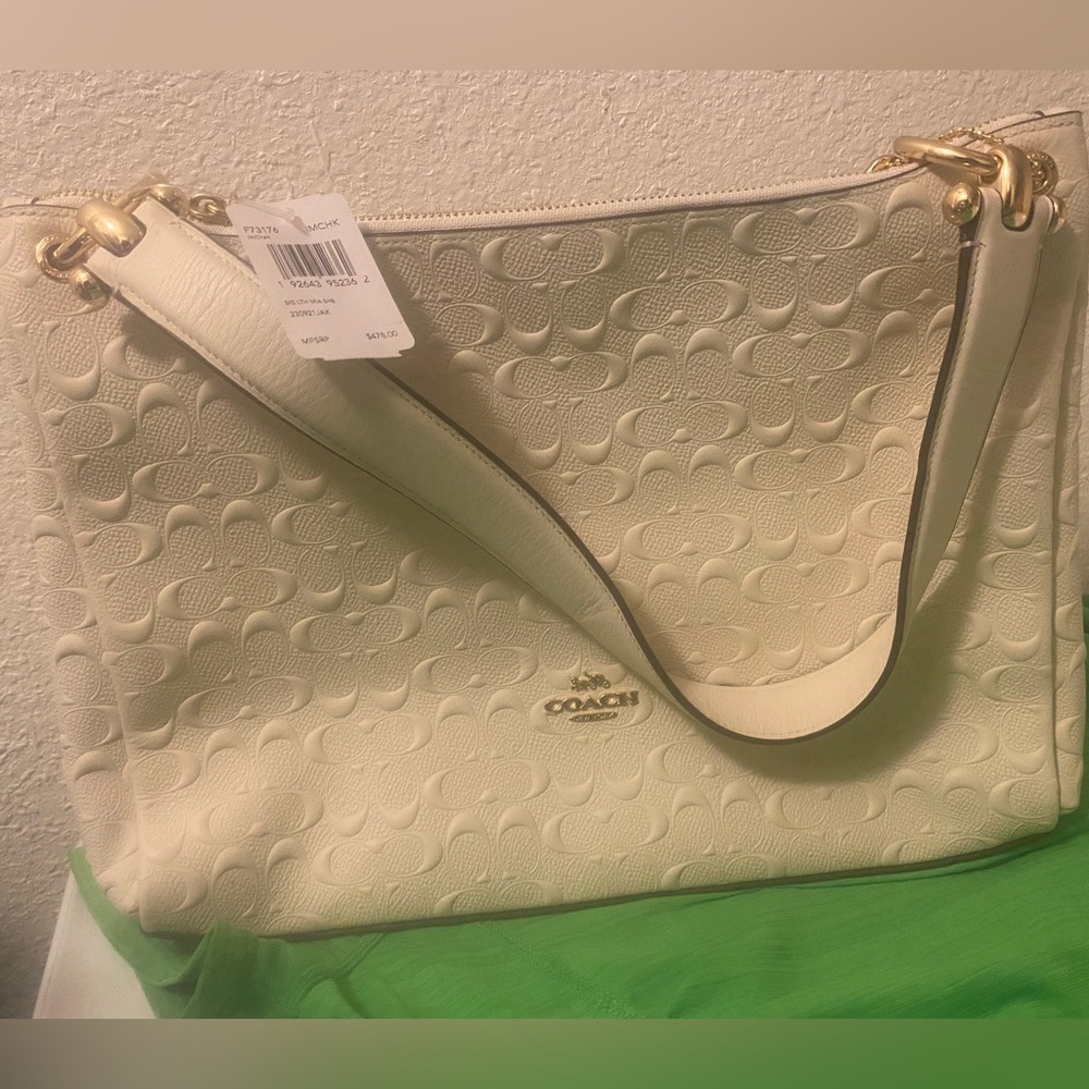 Brand new cream colored coach hand bag with tag still on